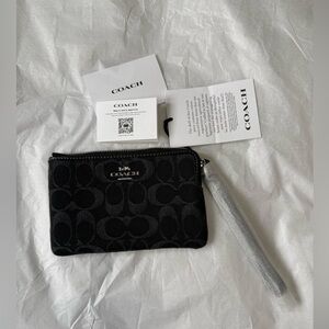 Corner Zip Wristlet
In Signature Denim